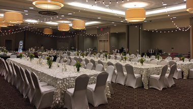 Long tables covered in white linens inside the banquet space at Hollywood Casino St. Louis, Missouri.