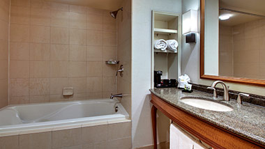 hotel bathroom with vanity and bathtub