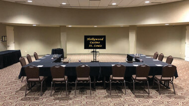 U-shaped meeting table pointing towards TV.