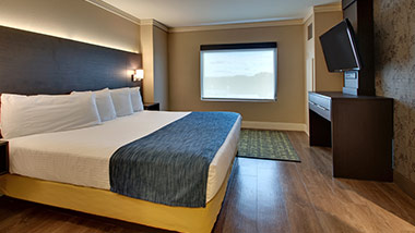 hotel suite with king bed, tv