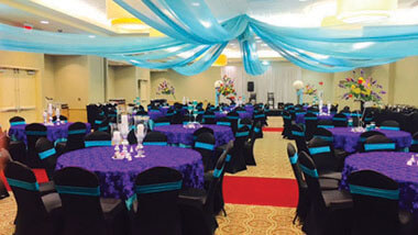 Hollywood Casino St. Louis' banquet space filled with purple covered tables and chairs.