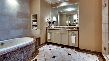 hotel bathroom with vanity and jacuzzi tub