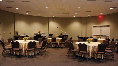 Hollywood Casino St. Louis' banquet space, filled with circular tables covered in white table cloths surrounded by black chairs.