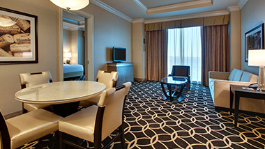 Hotel suite with tv, couch, dining table
