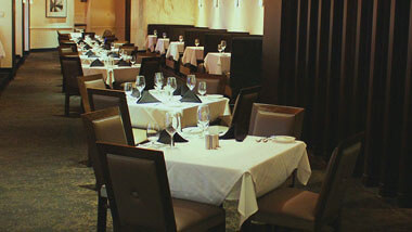 A row of four-top tables set for dinner inside of Final Cut Steakhouse at Hollywood Casino in St. Louis, Missouri.
