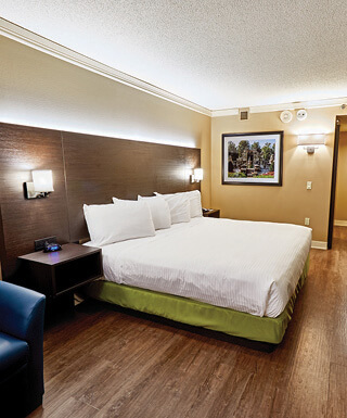 A king-size bed inside a hotel room at Hollywood Casino St. Louis Hotel.