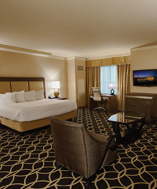 The king-size bed and sitting area inside the Rodeo Jr. Suite at Hollywood Casino hotel in St. Louis, Missouri.