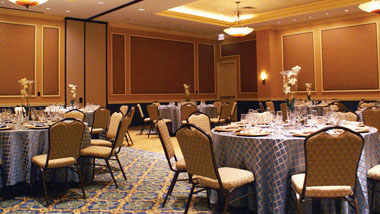 Tables are set up for an event inside a wood-paneled room at Hollywood Casino in St. Louis, Missouri.