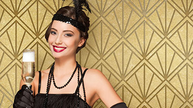 flapper holding champagne with a gold art deco background